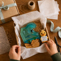 Order being packed carefully with tissue paper and ribbon